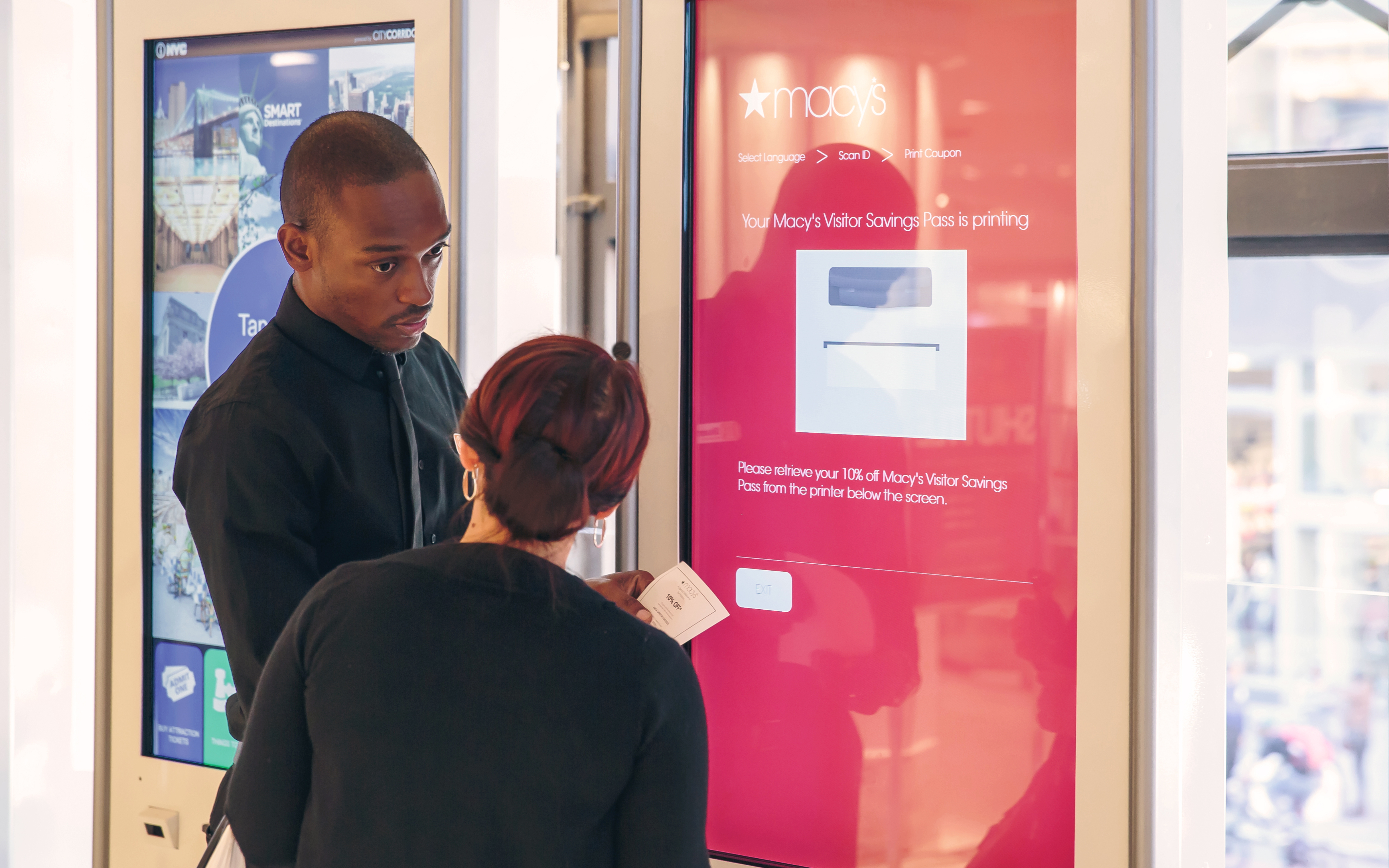Visitors using a Macy’s kiosk
