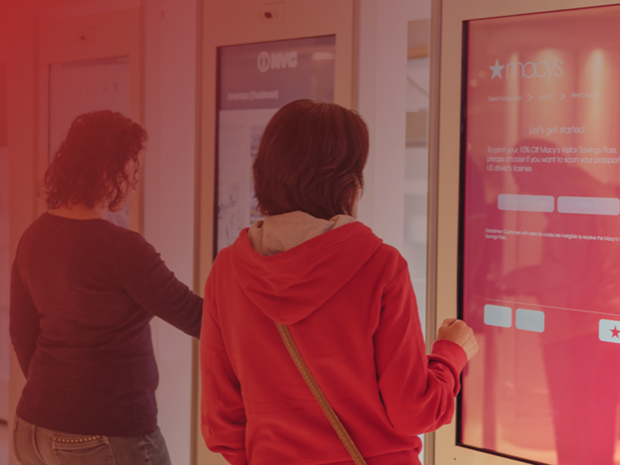 Visitors using a Macy’s touchscreen kiosk