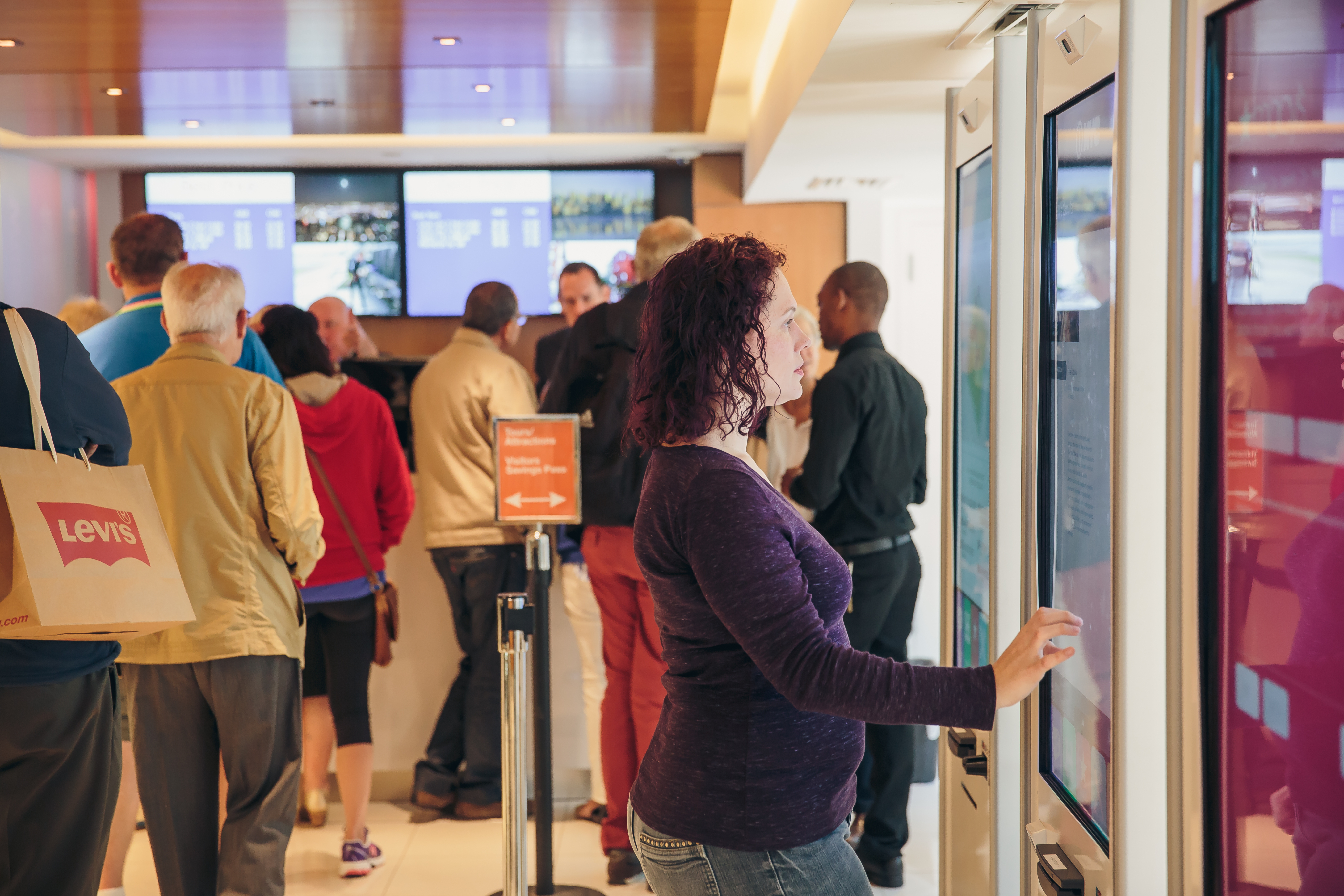 Visitors gathered around Macy’s information kiosks